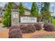 Stone sign for Level Creek by Century Communities, surrounded by lush landscaping, creating a welcoming entrance at 4931 Pauls Pointe, Sugar Hill, GA 30518