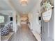 Bright and airy foyer with hardwood floors, a view into the living room and kitchen, and stylish decor at 4931 Pauls Pointe, Sugar Hill, GA 30518