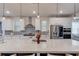 Spacious kitchen island with granite countertops, pendant lighting, and seating for four at 4931 Pauls Pointe, Sugar Hill, GA 30518