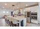 A Gourmet kitchen with granite countertops, a large center island with bar seating, and stainless steel appliances at 4931 Pauls Pointe, Sugar Hill, GA 30518