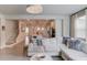 Bright living room with an open concept that leads into the kitchen and stairs at 4931 Pauls Pointe, Sugar Hill, GA 30518