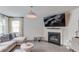 Cozy living room with a fireplace, tv, and comfortable sectional sofa near the windows at 4931 Pauls Pointe, Sugar Hill, GA 30518