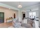 Open-concept living room with hardwood floors, neutral paint colors, and stylish furnishings at 4931 Pauls Pointe, Sugar Hill, GA 30518