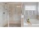Well-lit main bathroom featuring a stand-alone shower and soaking tub at 4931 Pauls Pointe, Sugar Hill, GA 30518