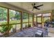 Relaxing screened-in porch with comfortable seating and a view of the landscaped backyard at 4931 Pauls Pointe, Sugar Hill, GA 30518