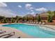 Community pool with lounge chairs, surrounded by landscaping and fencing, offers a relaxing oasis at 4931 Pauls Pointe, Sugar Hill, GA 30518