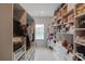 Spacious walk-in closet with custom shelving, drawers, and ample storage space for clothes and accessories at 4931 Pauls Pointe, Sugar Hill, GA 30518
