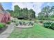 Landscaped backyard with a stone patio and seating area for outdoor enjoyment and entertaining at 1901 Paper Birch Cv, Grayson, GA 30017