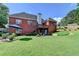 Large backyard with a lush lawn, patio, and mature trees offers plenty of room for outdoor activities at 1901 Paper Birch Cv, Grayson, GA 30017