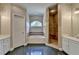 Bathroom featuring a bathtub, glass-enclosed shower, tiled floor and white cabinets at 1901 Paper Birch Cv, Grayson, GA 30017