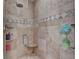 Modern bathroom shower featuring beautiful tile work, a built-in seat, and sleek glass door at 1901 Paper Birch Cv, Grayson, GA 30017