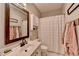 Well-lit bathroom featuring a vanity with sink, decorative mirror, and ample storage at 1901 Paper Birch Cv, Grayson, GA 30017