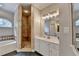 Bathroom showcasing a glass enclosed shower, a bathtub, double sinks and white cabinets at 1901 Paper Birch Cv, Grayson, GA 30017