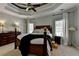 Cozy main bedroom with dark furniture, a ceiling fan and neutral walls at 1901 Paper Birch Cv, Grayson, GA 30017