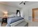 Comfortable bedroom with a cozy bed, bench, and windows for plenty of natural light at 1901 Paper Birch Cv, Grayson, GA 30017