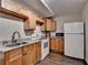 Functional kitchen with wood cabinets, granite countertops, and modern appliances at 1901 Paper Birch Cv, Grayson, GA 30017
