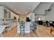 Open kitchen featuring white cabinetry, stainless steel appliances, granite counters, and an island with bar seating at 1901 Paper Birch Cv, Grayson, GA 30017