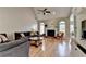 Spacious living room with a fireplace, hardwood floors, and large windows for natural light at 1901 Paper Birch Cv, Grayson, GA 30017