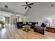 Open-concept living room with hardwood floors, vaulted ceiling, and stylish furnishings at 1901 Paper Birch Cv, Grayson, GA 30017