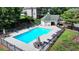 Community pool surrounded by a black fence with lounge chairs and tables for residents to enjoy at 1901 Paper Birch Cv, Grayson, GA 30017