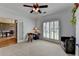 Room featuring neutral carpet, white trim, and large window with plantation shutters at 1901 Paper Birch Cv, Grayson, GA 30017