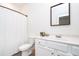 Bright bathroom with a white vanity, framed mirror, and tiled floors with shower curtain at 2106 Remy Ct, Kennesaw, GA 30144