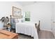 Bright bedroom featuring a bed with wood frame, a window and light colored walls and trim at 2106 Remy Ct, Kennesaw, GA 30144