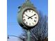 Vintage Kennesaw clock tower, adorned with Roman numerals, stands tall against a clear blue sky, marking time at 2106 Remy Ct, Kennesaw, GA 30144