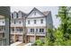 Townhouse exterior featuring white siding, stone accents, and a charming porch, ideal for outdoor relaxation and curb appeal at 2106 Remy Ct, Kennesaw, GA 30144