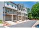 Exterior of townhomes with brick foundations and grey siding at 2106 Remy Ct, Kennesaw, GA 30144