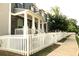 Charming home exterior featuring a white picket fence and inviting front porch with classic columns at 2106 Remy Ct, Kennesaw, GA 30144