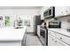 Well-lit kitchen features an island, stainless steel appliances, and plenty of counter space at 2106 Remy Ct, Kennesaw, GA 30144