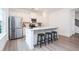 Modern kitchen with stainless steel appliances, white cabinets, quartz countertops, and breakfast bar at 2106 Remy Ct, Kennesaw, GA 30144