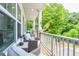 Relaxing porch with comfortable wicker seating, decorative pillows, and a view of mature trees at 2106 Remy Ct, Kennesaw, GA 30144