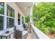 Relaxing porch with outdoor seating, stone pillars, and natural views at 2106 Remy Ct, Kennesaw, GA 30144