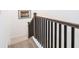 Modern staircase with dark railings, leading up to the next floor of the home at 2106 Remy Ct, Kennesaw, GA 30144