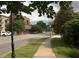 Street view showing a sidewalk, road, and commercial buildings in a walkable neighborhood at 2106 Remy Ct, Kennesaw, GA 30144
