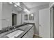 Elegant bathroom with a double sink vanity, granite countertops, and updated fixtures at 5149 Roswell Rd # 7, Atlanta, GA 30342