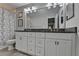 Bathroom vanity featuring double sinks, granite countertop, and plenty of storage at 5149 Roswell Rd # 7, Atlanta, GA 30342
