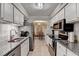 Galley kitchen features granite countertops and stainless steel appliances at 5149 Roswell Rd # 7, Atlanta, GA 30342