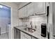 Granite countertops and stainless steel appliances in kitchen area leading to laundry room at 5149 Roswell Rd # 7, Atlanta, GA 30342