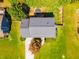 Birds eye view of house showing roof, green lawn, driveway and mature landscaping at 5425 Windswept Trce, Sugar Hill, GA 30518