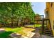 Large backyard featuring mature trees, a wood deck, and a trampoline offers a great outdoor living space at 5425 Windswept Trce, Sugar Hill, GA 30518