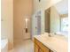 Bright bathroom featuring a tub, sink with vanity, and a view of the outdoor scenery at 5425 Windswept Trce, Sugar Hill, GA 30518