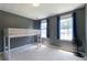 Bedroom with gray walls, two large windows with blinds, and a bunk bed at 5425 Windswept Trce, Sugar Hill, GA 30518
