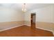 Bright dining room featuring hardwood floors, neutral paint, chair rail, and a chandelier at 5425 Windswept Trce, Sugar Hill, GA 30518