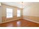 Bright dining room featuring hardwood floors, neutral paint, chair rail, and a chandelier at 5425 Windswept Trce, Sugar Hill, GA 30518