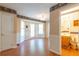 Dining room with hardwood floors that leads to a view of a patterned bathroom with a vintage look at 5425 Windswept Trce, Sugar Hill, GA 30518