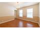 Bright dining room featuring hardwood floors, neutral paint, chair rail, and a chandelier at 5425 Windswept Trce, Sugar Hill, GA 30518