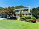 Charming two-story home with yellow exterior, black shutters, and well-manicured lawn at 5425 Windswept Trce, Sugar Hill, GA 30518
